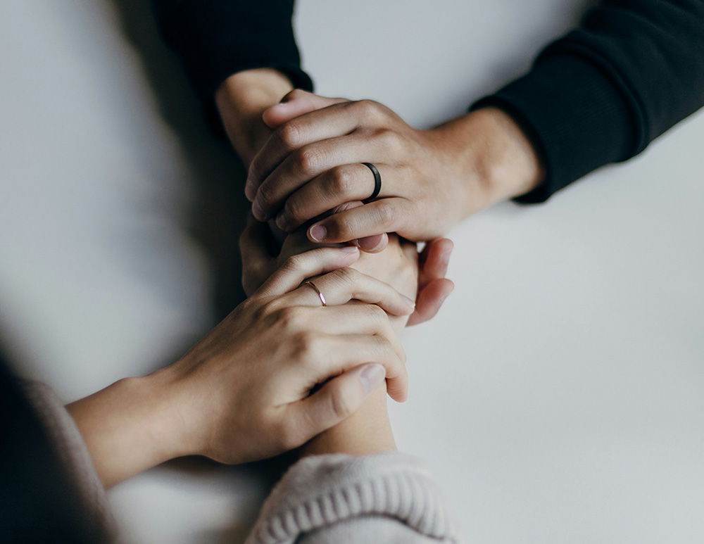 Close up of two women holding hands