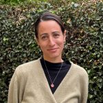 Portrait photo of Ingrid Salazar in front of hedge wall