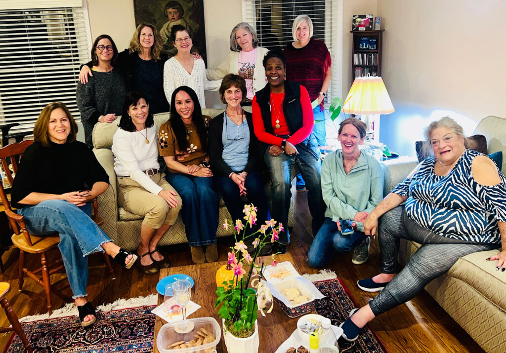 Photo of all the members of the Altadena Book Lovers gathered around two couches.