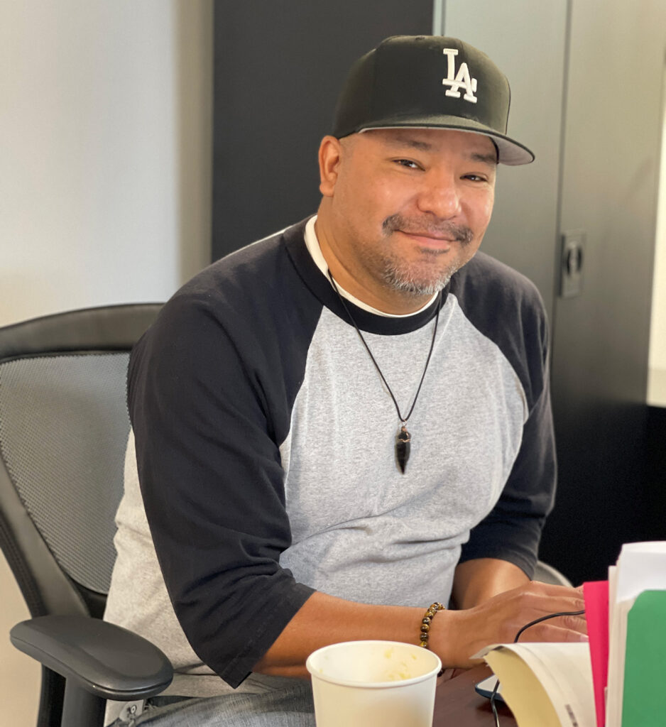 Photograph of Isaac Arreola wearing a black LA Dodgers baseball cap and a black and grey baseball t-shirt.